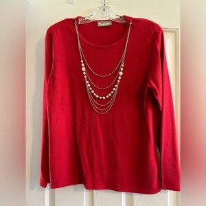 Red sweater with attached necklace